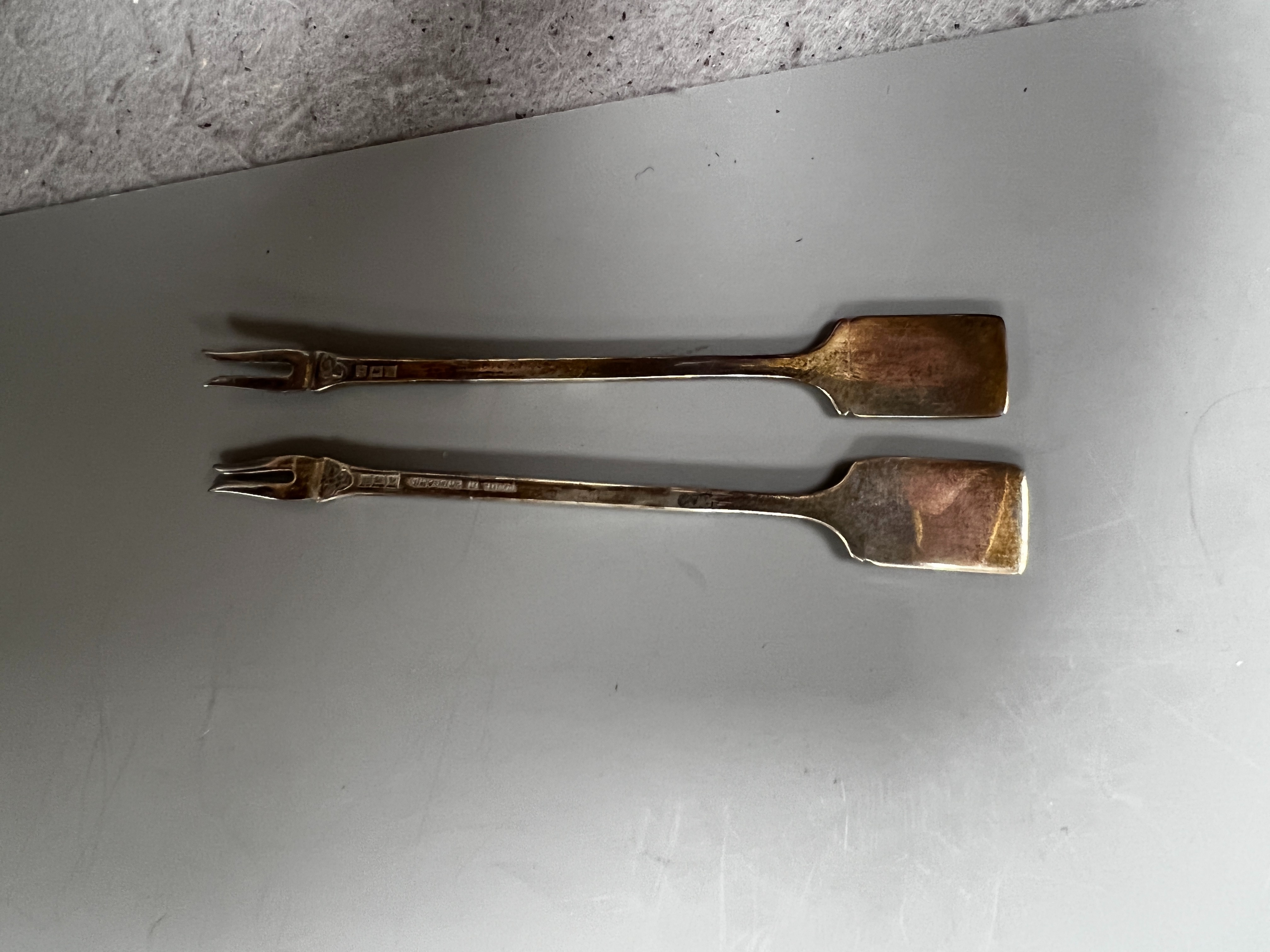 A cased set of twelve early 1960's silver and enamel cocktail sticks, by Garrard & Co, with playing card terminals, Birmingham, 1961.